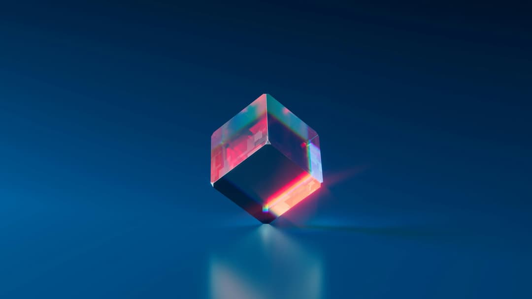 A glass cube standing on one edge providing a colorful prism view